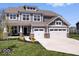 Beautiful two-story home boasts a manicured lawn, a two-car garage and a charming front porch with brick accents at 16688 Bowesmont Dr, Fortville, IN 46040