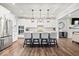 Modern kitchen with stainless steel appliances, white cabinetry, and large center island with pendant lighting at 16688 Bowesmont Dr, Fortville, IN 46040