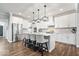 Spacious, light-filled kitchen featuring white cabinets, a large island with seating, and modern appliances at 16688 Bowesmont Dr, Fortville, IN 46040