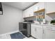 Bright laundry room with ample storage, modern washer and dryer, and stylish countertops at 16688 Bowesmont Dr, Fortville, IN 46040