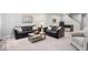 Spacious living room featuring plush carpeting, modern furniture, and a foosball table for entertainment at 16688 Bowesmont Dr, Fortville, IN 46040