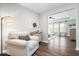Comfortable living room with an armchair and hardwood floors, with a view to the main bedroom at 16688 Bowesmont Dr, Fortville, IN 46040