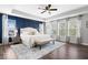 Beautiful main bedroom with wood floors, large windows and a decorative blue accent wall at 16688 Bowesmont Dr, Fortville, IN 46040
