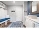 Contemporary mudroom area with blue bench seating, hooks for coats, storage cabinets, and tiled flooring at 16688 Bowesmont Dr, Fortville, IN 46040