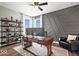 Bright office with custom wood desk, shelving, black accent wall, and large windows for natural light at 16688 Bowesmont Dr, Fortville, IN 46040