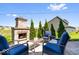 Charming outdoor fireplace with cozy seating area for enjoying evenings by the fire at 16688 Bowesmont Dr, Fortville, IN 46040