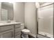 Modern bathroom featuring a walk-in shower with glass doors, vanity with quartz countertop and wood look flooring at 17372 Graley Pl, Westfield, IN 46074