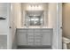 Bathroom featuring double vanity with quartz countertop and modern fixtures, mirror reflecting the tiled shower at 17372 Graley Pl, Westfield, IN 46074