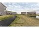 Rear view of townhomes with ponds and green space creating a relaxing and scenic view at 17372 Graley Pl, Westfield, IN 46074