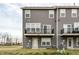 Rear of townhomes featuring private balconies, outdoor access, and coordinated exterior finishes at 17372 Graley Pl, Westfield, IN 46074