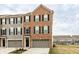 Charming brick-front townhome with a one-car garage and well-maintained landscaping at 17372 Graley Pl, Westfield, IN 46074