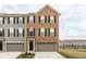 Charming brick-front townhome with a one-car garage and well-maintained landscaping at 17372 Graley Pl, Westfield, IN 46074