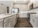 Modern kitchen island with stainless steel dishwasher, appliances, and white subway tile backsplash at 17372 Graley Pl, Westfield, IN 46074