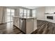 Kitchen island offers stainless steel dishwasher, sink, and view to fireplace at 17372 Graley Pl, Westfield, IN 46074