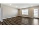 Bright living room features sleek wood floors, neutral walls, and natural light from the window and glass paneled door at 17372 Graley Pl, Westfield, IN 46074
