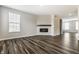 Cozy living room featuring hardwood floors and a fireplace with a stone surround at 17372 Graley Pl, Westfield, IN 46074