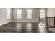 Spacious living room with hardwood floors, large windows that let in plenty of natural light, and wrought iron railings at 17372 Graley Pl, Westfield, IN 46074