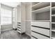 Walk-in closet with custom shelving, drawers, carpeted floor, and a window for natural light at 17372 Graley Pl, Westfield, IN 46074