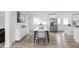 Bright dining area featuring a modern table set and stainless steel refrigerator at 207 Stephen Ct, Indianapolis, IN 46280