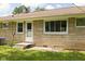Stone ranch style home with a back porch and green lawn at 207 Stephen Ct, Indianapolis, IN 46280