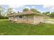 Stone ranch home with updated siding and a lush green lawn at 207 Stephen Ct, Indianapolis, IN 46280