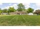 Charming ranch home displaying a large front yard and an inviting stone façade at 207 Stephen Ct, Indianapolis, IN 46280