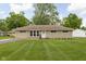 Charming brick ranch home with lush green lawn and mature trees, perfect for suburban living at 207 Stephen Ct, Indianapolis, IN 46280