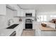 Well-lit kitchen featuring white cabinets, quartz countertops, and stainless steel appliances at 207 Stephen Ct, Indianapolis, IN 46280