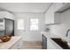 Bright kitchen featuring white cabinets, stainless steel appliances, and a butcher block countertop at 207 Stephen Ct, Indianapolis, IN 46280