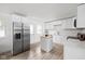 Modern kitchen features white cabinets, stainless steel refrigerator, and a functional center island at 207 Stephen Ct, Indianapolis, IN 46280