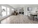Open-concept living space features a cozy fireplace, large windows, and sleek light wood flooring at 207 Stephen Ct, Indianapolis, IN 46280