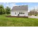 The backyard features green grass, gray siding, nice windows, and a small patio area at 218 Urban St, Danville, IN 46122