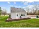 The backyard features green grass, gray siding, nice windows, and a small patio area at 218 Urban St, Danville, IN 46122