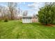 Backyard featuring a lawn, storage shed, and partial fencing at 218 Urban St, Danville, IN 46122