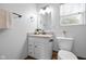 Compact bathroom featuring a vanity with granite countertop, a toilet, and natural light at 218 Urban St, Danville, IN 46122