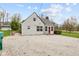 Charming home featuring neutral siding, a red front door, and a gravel driveway at 218 Urban St, Danville, IN 46122