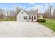 Charming home featuring neutral siding, a red front door, and a gravel driveway at 218 Urban St, Danville, IN 46122