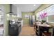 Sunlit kitchen with black appliances, an eat-in table, and stainless steel refrigerator at 218 Urban St, Danville, IN 46122