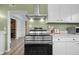 Modern kitchen features a sleek black range with stainless steel vent hood at 218 Urban St, Danville, IN 46122