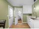 Bright kitchen with stainless faucet, white cabinets, and backyard door access at 218 Urban St, Danville, IN 46122