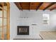 Bright living room with a decorative fireplace, wood ceilings and light-colored laminate floors at 218 Urban St, Danville, IN 46122
