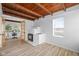 Bright living room with a decorative fireplace, wood ceilings and light-colored laminate floors at 218 Urban St, Danville, IN 46122