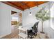 Well-lit home office with wood ceiling and view to living room beyond french doors at 218 Urban St, Danville, IN 46122