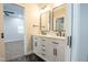 Bathroom with a double vanity, modern fixtures, and an open doorway to a bedroom at 221 Eastern Ave, Indianapolis, IN 46201