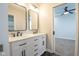 Bathroom with double vanity sinks, modern black hardware, and an open doorway to a bedroom at 221 Eastern Ave, Indianapolis, IN 46201
