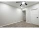 Carpeted bedroom features ceiling fan, neutral paint, and white doors at 221 Eastern Ave, Indianapolis, IN 46201
