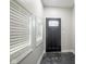 Entryway with tile floor, sidelight windows and transom window over the front door at 221 Eastern Ave, Indianapolis, IN 46201