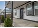 Inviting front porch with black trim, white siding, and stylish front door at 221 Eastern Ave, Indianapolis, IN 46201