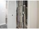View of the furnace inside of a utility closet with white slatted doors at 221 Eastern Ave, Indianapolis, IN 46201