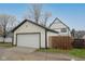 Exterior view of the detached garage next to the house with a fresh lawn at 221 Eastern Ave, Indianapolis, IN 46201